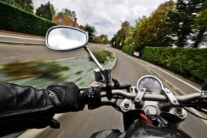 A motorcycle driving down the road from the rider's point of view