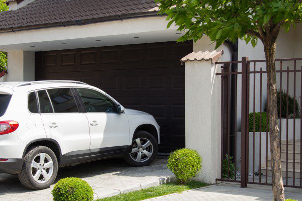 A white SUV entering a home garage