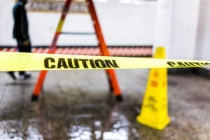 Caution tape blocks a hazardous area at a business