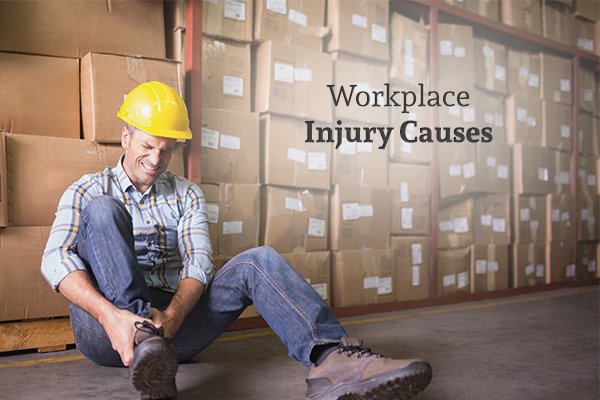 A worker holding his hurt leg in a lot of pain, sitting against stacks of boxes, beside the words "Workplace Injury Causes"