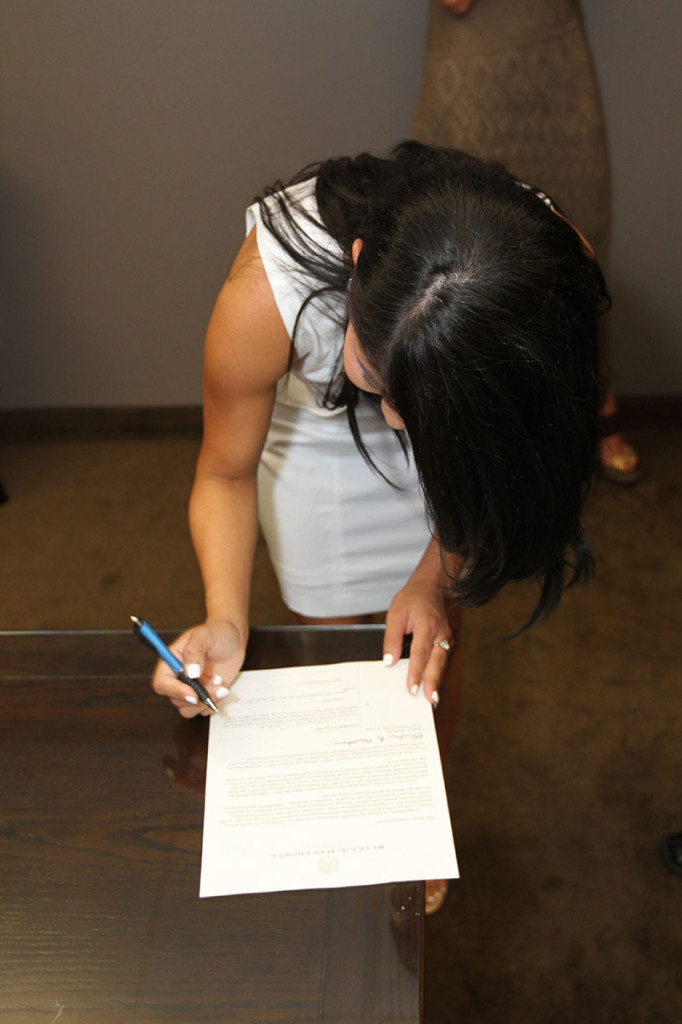 Cassandra Garcia signing a document