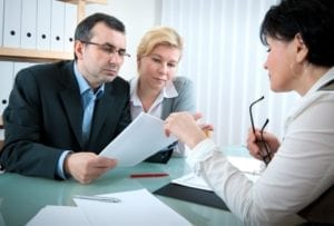 Couple talking to a lawyer about filing a wrongful death claim