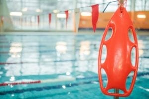 A safety buoy in front of a pool. 