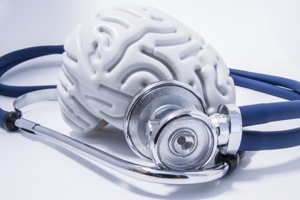 A brain with a stethoscope wrapped around it. 