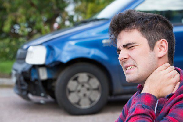 A man is suffering from whiplash after a car accident.