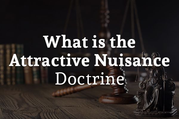 A desk with a gavel and a legal scale with the words, what is the attractive nuisance doctrine