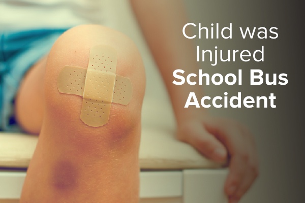 A child sitting on an examination table with a band-aid on his knee with words that say, child was injured school bus accident.