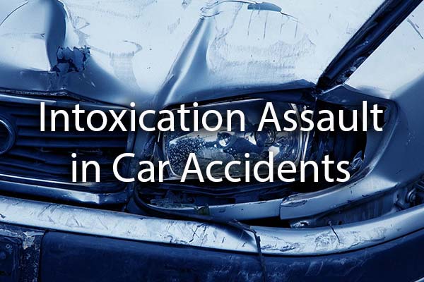 A wrecked car with the words, intoxication assault in Car Accidents