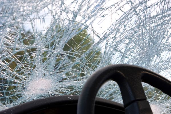 A cracked windshield after a car accident.