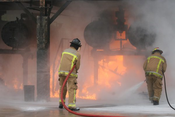 A picture of firefighters putting out a fire at a chemical plant.