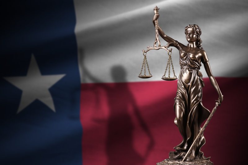 A legal statue with the Texas flag.